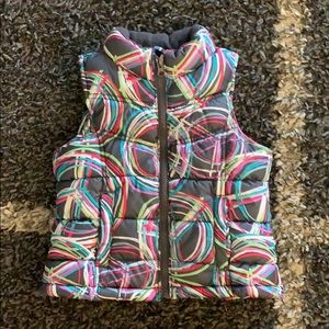Puffer vest, multi-color. Geometric design.